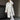 Luxury women's white shearling long winter coat featuring a sleek overcoat design, emphasizing the neck and waist with elegant sleeves, made from natural materials, ideal for fashion-forward winter outerwear.