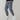 Men's black corduroy cargo pants featuring an ankle-tapered design, suitable for urban style. The pants have visible cargo pockets and a fitted waist, emphasizing both casual and sporty aesthetics.