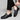 Men's blue leather loafers with metal buckle, styled with a blazer and watch, emphasizing a fashionable and sophisticated look.