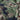 Men's durable military-style camouflage jacket featuring a mix of brown, grey, and beige tones, with long sleeves and tactical outerwear design.