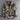 Men's military-style camouflage jacket with long sleeves, featuring a durable design suitable for tactical use. The jacket showcases a classic collar and a distinctive camo pattern, blending fashion design with the practical aesthetics of a uniform.