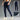 Men's lightweight jogger pants with zipper pockets and adjustable waist, shown in a casual setting. The pants display a relaxed fit around the legs and thighs, suitable for fashion-forward individuals seeking comfort and style.