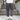 Men's navy blue joggers featuring a lightweight design, water-resistant fabric, and zipper pockets, shown on a person standing.