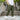 Men's navy blue joggers showcased with a focus on their lightweight, water-resistant fabric and convenient zipper pockets, being worn by a standing model.