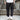 Men's navy blue joggers with a lightweight and water-resistant design, featuring zipper pockets, shown standing, highlighting the waist, thigh, and knee areas.