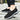 Men's navy waterproof slip-on walking shoes shown on a person's feet, highlighting the lightweight and anti-slip design. The shoes are styled with casual sportswear.