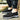 Men's navy slip-on walking shoes showcased outdoors, featuring a lightweight and waterproof design with anti-slip soles, paired with denim jeans on grass.