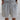 Men's oversized white t-shirt featuring a casual urban fashion loose fit with short sleeves and a round collar, showcased on a model with a neutral background.