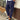 Men's slim fit brown pleated trousers in 4XL, showcasing lightweight urban fashion design, with visible sections of a dress shirt, sleeve, and waist area against a flooring background.
