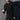 Men's slim-fit stretch cotton crew neck shirt in black, size 3XL, featuring a casual athleisure style. The shirt is modeled by a bearded man with visible sleeves and a focus on the waistline, fitting within sportswear and jersey fashion trends.