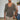 Men's slim fit V-neck thermal knit sweater in gray, size XL, showcasing earth tone design. The image highlights the shoulder and neck area, with a focus on the long sleeves and fit around the waist. A bearded man wearing the sweater, with an emphasis on the casual styling.