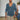 Men's blue slim fit V-neck thermal knit sweater in XL size, featuring earth tone hues, with visible shoulder and sleeve detailing, and worn by a person with a beard.