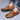 Men's tan leather slip-on loafers with a sleek design, showcasing a comfortable and lightweight construction suitable for fashion-conscious individuals.