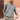 Men's white ribbed half-zip sweater in light gray, shown in an XL size, worn by a model with a beard, highlighting the casual lightweight knitwear design and fashion appeal.