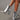 Silver high heel ankle boots showcased on a model's legs, highlighting the trendy metallic finish and sleek silhouette.