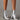 Metallic silver high heel ankle boots worn with a stylish dress, showcasing the trendy fashion statement and elegant design.
