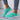 Mint green breathable running sneakers with lightweight and comfortable design, shown from a side angle. The sneakers feature a mix of azure and white tones with black accents, highlighting their eco-friendly textile material.