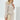 Luxury designer women's workwear featuring a multicolor tweed jacket and skirt suit, showcasing outerwear with structured shoulders, dress shirt collar, long sleeves, and a grey and beige color palette.