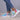 Women's multicolor breathable lightweight athletic sneakers worn by a person, paired with blue denim jeans.