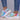 Multicolor women's breathable lightweight athletic sneakers featuring a blend of white, azure, aqua, and violet colors, showcased on a human foot with a focus on fashion-forward textile design.