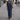 Navy blue linen summer suit for mature women, featuring a casual two-piece design with a dress shirt and tailored pants, modeled by a woman standing outdoors near a bicycle.