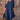 Woman wearing a navy blue ruffle dress with round neck and short sleeves, showcasing a chic and casual summer fashion style.