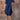 Woman wearing a navy blue ruffle dress with round neck, short sleeves, and casual summer style.