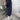 Navy blue shirt dress for women, featuring short sleeves and a knee-length design, styled on a model standing in front of a white door.