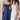 Navy ruched beach dress featuring adjustable bust, modeled by a woman, showcasing a strapless design and elegant one-piece silhouette suitable for women's fashion.