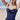 Navy ruched beach dress for women featuring an adjustable bust, sleeveless design, and stylish fashion-forward look.