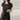 Woman wearing a navy striped short sleeve midi dress with a lightweight belted design, suitable for summer fashion.