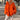 Orange women's chunky knit sweater with an oversized V-neck pullover design, featuring long sleeves and a loose fit around the waist and shoulders.