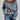 Oversized blue houndstooth chunky knit sweater for women, styled with jeans, highlighting the cozy and fashionable winter outerwear design.