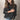 Oversized chunky knit turtleneck sweater in black, designed for cozy fall fashion, shown in size 5XL. The sweater features a high turtleneck, long sleeves, and a relaxed fit, perfect for layering over jeans. Model is smiling, showcasing the comfortable and stylish nature of the garment.