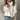 Oversized chunky knit turtleneck sweater in white, designed for a cozy fall fashion look, showcased on a model wearing size 5XL. The model pairs the sweater with jeans, highlighting the relaxed fit and stylish appeal of the sweater.