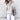 Oversized cowl neck knit sweater in a chunky and cozy style, featuring long sleeves and a relaxed fit in a 3XL size, showcasing a white textile with a subtle tartan pattern.