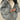 Oversized grey puffer jacket for women, showcasing a fashionable winter coat design with long sleeves and a high neck, emphasizing comfort and warmth.