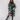 Oversized green plaid coat with tartan pattern, complemented by a stylish fedora hat, suitable for chic winter urban fashion.