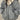 Oversized women's black bomber puffer jacket featuring a trendy winter fashion style with a high collar, long sleeves, and a quilted design for added warmth and comfort.