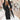 A pastel pink wool longline blazer designed as a women's chic winter coat, featuring a tailored fit with long sleeves, a classic collar, and button detailing. The coat drapes elegantly past the waist, showcasing a fashionable winter style.