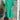 Woman wearing a green mid-length spring dress with a casual and elegant style, suitable for warm weather; the dress is lightweight and designed for comfort.