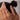 A woman's hand wearing a lightweight 18K gold-plated stainless steel pearl ring on her finger.