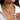 Elegant pearl necklace with gold starfish and seashell charms showcased on a woman's neck and shoulder.