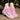 Pink breathable women's running shoes with a lightweight air cushion design placed on grass, featuring a stylish magenta and electric blue pattern.