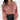 Pink cropped V-neck blouse with puffed sleeves, featuring a casual chic design.