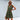 Light green sleeveless V-neck linen tiered mini dress worn by a person, featuring a summer fashion style and complemented by sunglasses.