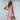 Sleeveless pink linen tiered mini dress with a V-neck, perfect for summer fashion.