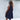 Sleeveless pink linen tiered mini dress with a V-neck design, modeled on a person, highlighting the dress's lightweight and fashionable summer style.