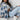 A blue oversized shacket with a plaid pattern, designed as trendy women's casual outerwear, shown in extra-large size. The shacket features long sleeves and a relaxed fit for comfort, suitable for layering over other clothing.