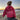 Pink tie-dye hoodie with the words "Self-Love" printed on it, worn by a smiling individual standing on a beach, with a clear sky and ocean in the background, conveying a sense of happiness and leisure.